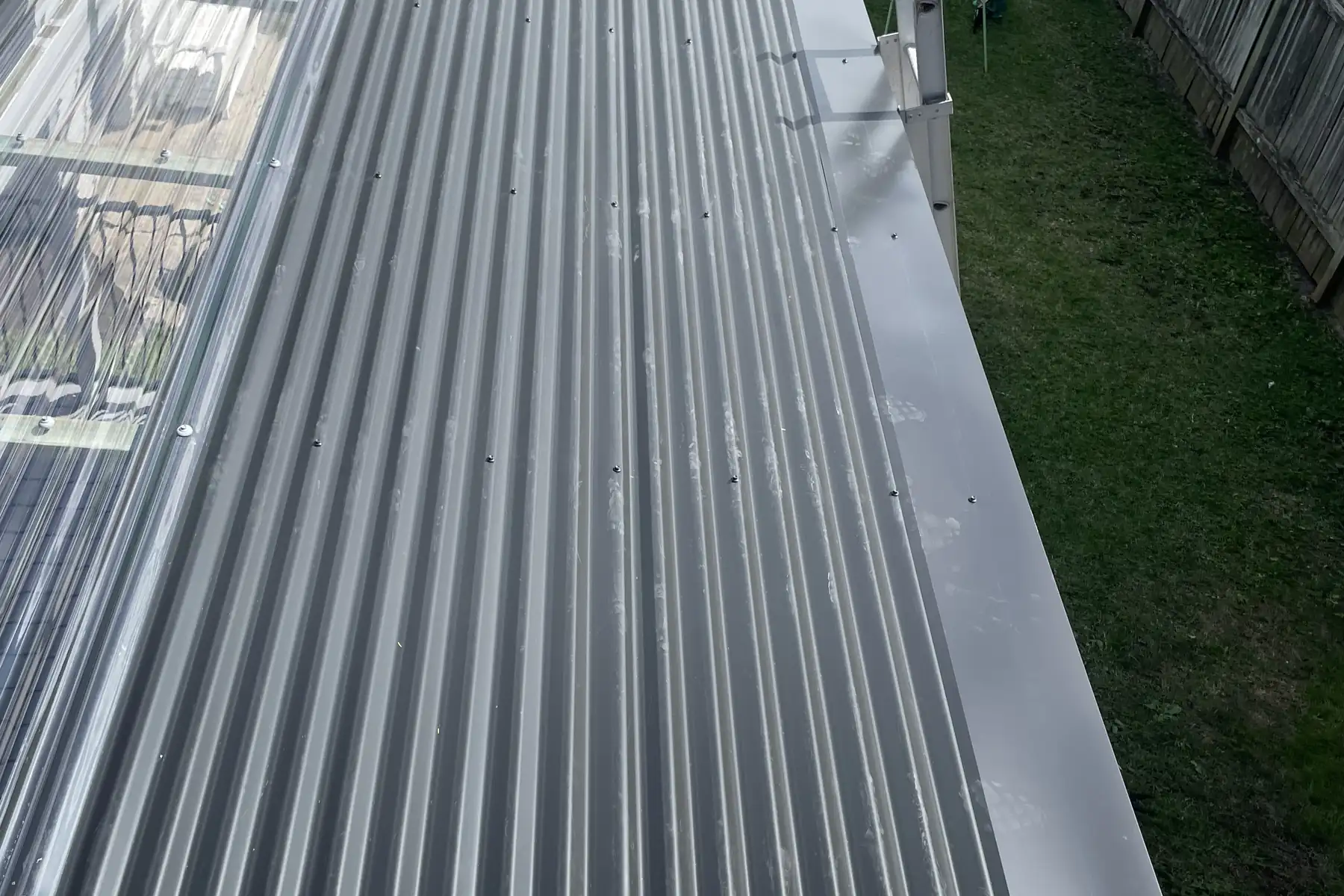 A long run of new sheeting looking out over a grassed yard and a paling fence